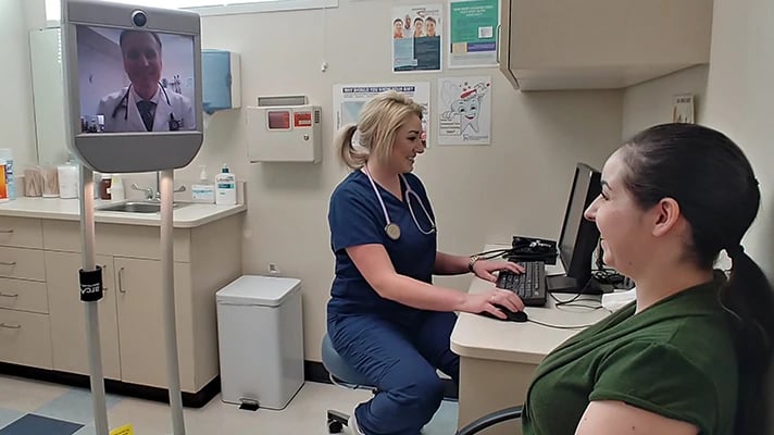 A patient talking to a doctor via screen